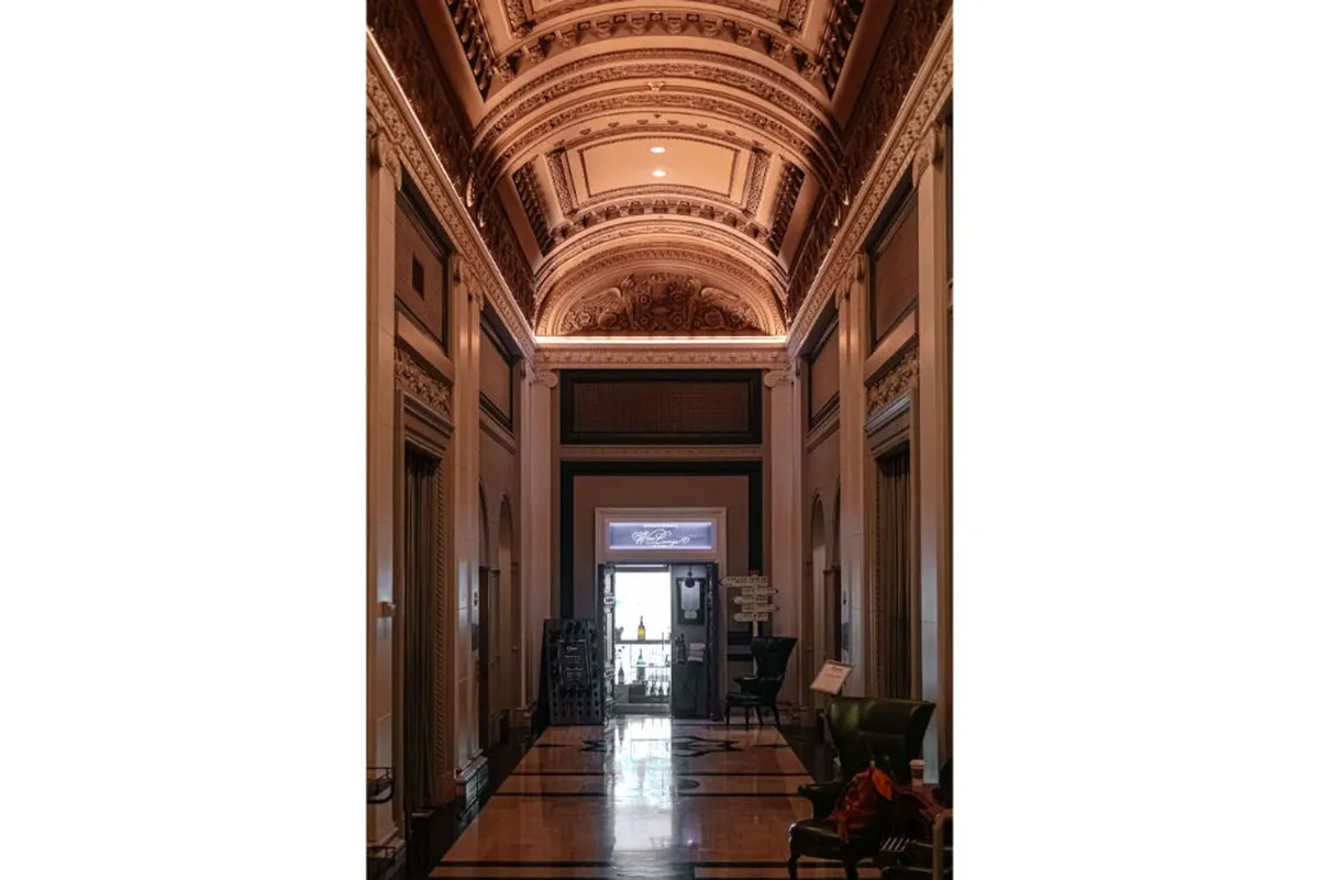 A grand interior with an ornate ceiling, detailed wall moldings, and an impressive entrance, often used for art exhibitions and historical tours. The space exudes opulence and cultural richness, ideal for memorable gatherings and artistic showcases.